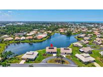 Beautiful aerial view of a waterfront home with lush landscaping and gorgeous curb appeal in a desirable neighborhood at 75 Inlets Blvd # 75, Nokomis, FL 34275