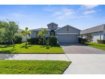 Charming single story home featuring a manicured front yard and neutral color scheme at 12565 Ryegrass Loop, Parrish, FL 34219