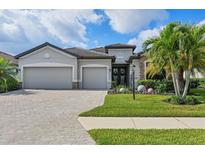 Beautiful single-Gathering home with a well-manicured lawn, stone accents, and a three-car garage at 18045 Polo Trail St, Bradenton, FL 34211
