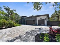 Beautifully landscaped modern home featuring a spacious driveway and a sleek two-car garage at 2632 Hawthorne St, Sarasota, FL 34239