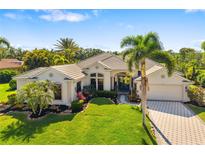 Beautiful single-story home with lush lawn and manicured tropical landscaping at 356 Blackbird Ct, Bradenton, FL 34212