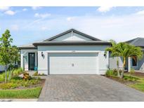 Charming single-story home featuring a spacious two-car garage and a beautifully landscaped front yard at 6248 Fish Eagle Ct, Nokomis, FL 34275