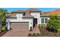 Charming single-Gathering home with a tile roof, attached garage, and beautifully landscaped front yard at 6290 Mesa Gln, Bradenton, FL 34203