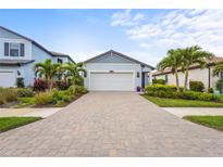 Charming single-Gathering home with a manicured front yard and a brick driveway at 6295 Crested Eagle Ln, Nokomis, FL 34275