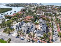 Sweeping aerial view of new construction homes in a coastal community with lush landscaping and water views at 114 Fillmore Dr, Sarasota, FL 34236