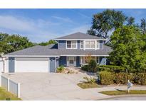 Charming two-story blue home with a spacious two-car garage, a well-kept lawn, and a welcoming front entrance at 1310 91St Nw Ct, Bradenton, FL 34209