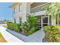 Charming condominium exterior featuring lush landscaping and a screened-in porch at 2103 L Pavia Blvd # 2103, Venice, FL 34292