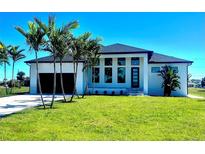 Beautiful single-Gathering home with a modern design, lush lawn, and elegant black trim at 217 Rotonda S Blvd, Rotonda West, FL 33947