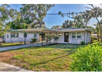 Charming single story home with a carport and a well-manicured front yard at 2947 Goodrich Ave, Sarasota, FL 34234