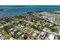 Stunning aerial view showcases a waterfront community with homes near the coast and beautiful blue ocean at 4420 101St W St, Bradenton, FL 34210