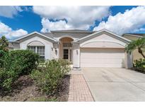 Charming single-story home with well-maintained landscaping and attached two-car garage at 4610 Runabout Way, Bradenton, FL 34203