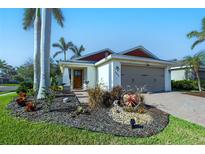 Charming single-story home with palm trees, garden, brick driveway, and well-maintained landscaping at 4838 San Ortebello Dr, Bradenton, FL 34208