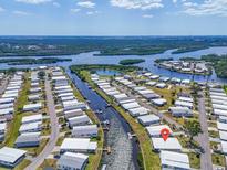 Waterfront community featuring boat canals, residences, and the Gulf of Mexico in the background at 649 Fairmount Dr, North Port, FL 34287