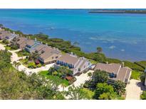 Waterfront homes with lush landscaping and stunning views of the bay at 78 Tidy Island Blvd, Bradenton, FL 34210