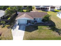 Aerial shot showcasing the home's layout, driveway, lawn, and surroundings at 807 Mohawk Rd, Venice, FL 34293