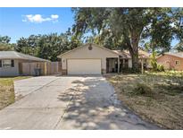 Charming single Gathering home featuring a two-car garage, well-maintained lawn, and mature trees for shade at 920 36Th W St, Bradenton, FL 34205