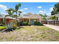 Charming single-story home with a bright blue door, well-kept landscaping, and a brick driveway at 1052 32Nd St, Sarasota, FL 34234