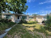 Charming single-story home featuring a well-maintained front yard and a cozy porch area at 1127 Tyrone N Ct, St Petersburg, FL 33710