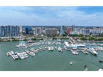 Stunning aerial view of a waterfront condo building and a marina filled with boats at 1255 N Gulfstream Ave # 402, Sarasota, FL 34236