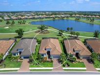 Stunning aerial view of home on golf course with lake view and beautifully landscaped yard, surrounded by lush greenery at 15037 Montello Way, Lakewood Ranch, FL 34211