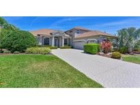 Beautiful single-Gathering home featuring a large front yard and patterned concrete driveway at 15518 29Th E St, Parrish, FL 34219