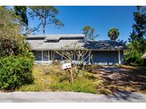Charming home with a welcoming front yard and a convenient attached two-car garage at 2511 Lords Ln, Sarasota, FL 34231
