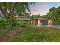 Charming single-story home with a well-manicured lawn, mature trees, and a two-car garage at 2778 Greendale Dr, Sarasota, FL 34232