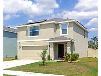 Charming two-story home with a manicured lawn, solar panels, and a welcoming front entrance at 2969 Great Abaco Way, Bradenton, FL 34208