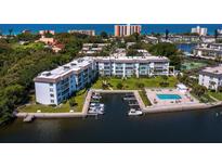 Waterfront condos boast a pool, boat docks, and verdant grounds with ocean views at 565 Sutton Place, Longboat Key, FL 34228
