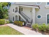 Charming two-story condo with well-maintained landscaping and inviting entryway with stairs and portico at 7639 Fairway Woods Dr # 605, Sarasota, FL 34238