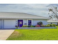 Charming single-story home with a well-maintained lawn and colorful landscaping at 909 68Th W St, Bradenton, FL 34209