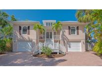 Charming two-story home with well-maintained landscaping and a welcoming entryway at 5024 Commonwealth Dr, Sarasota, FL 34242
