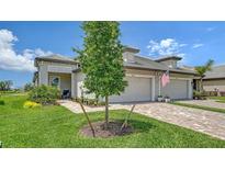 Charming single-story home with a well-manicured lawn and brick paved driveway leading to a two car garage at 17946 Cherished Loop, Bradenton, FL 34211