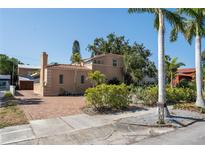 Charming Mediterranean home featuring a brick driveway, lush landscaping, and a classic tile roof at 344 N Lantana N Ave, Sarasota, FL 34243