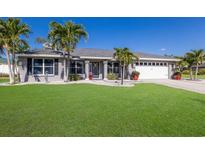 Beautiful single-story home with well-manicured lawn and tropical landscaping at 3889 Canopy Way, Sarasota, FL 34235