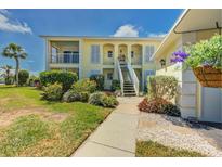 Charming two-story condo building featuring lush landscaping and classic architectural details, creating a welcoming curb appeal at 446 Cerromar Rd # 291, Venice, FL 34293