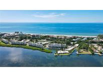 Breathtaking aerial view of waterfront condos with private docks on the Gulf of Mexico's beautiful shoreline at 4968 Gulf Of Mexico Dr # Villa 22, Longboat Key, FL 34228