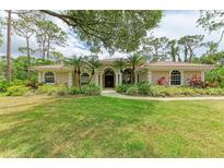 Beautiful one-story home with mature landscaping and tile roof at 5533 Ashley Pkwy, Sarasota, FL 34241