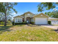 Charming, one-story home with well-maintained lawn, landscaping, and a two-car garage at 1010 Tropical Dr, Bradenton, FL 34208