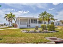 Charming single-story home with a well-manicured lawn, rock garden, and inviting porch at 1404 44Th E Ave, Ellenton, FL 34222