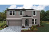 Charming two-story home featuring a two-car garage, muted gray exterior, arched entry, and well-manicured landscaping at 1737 Cobb Trl, Parrish, FL 34219