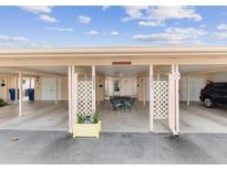 Carport featuring dining area with table and chairs under the covered parking, offering outdoor relaxation at 5057 Live Oak Cir # 86, Bradenton, FL 34207