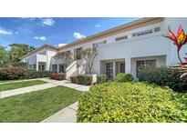 Charming townhome featuring well-maintained landscaping, with stairway access to upper units and inviting curb appeal at 5217 Wedgewood Ln # 21, Sarasota, FL 34235