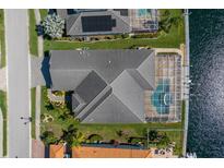 An overhead view of the home featuring a screened-in pool and a beautiful view of the waterway at 569 Mast Dr, Bradenton, FL 34208