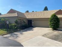Charming single-story home with a two-car garage, well-maintained landscaping, and a unique tiled roof at 5712 34Th W Ct, Bradenton, FL 34210
