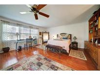 Spacious bedroom features hardwood floors, ceiling fan and lots of natural light at 705 Whitfield Ave, Sarasota, FL 34243