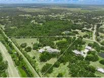 Expansive estate on acreage with a luxurious home, pool, and lush landscaping surrounded by a defined property line at 7234 Letitia Ln, Sarasota, FL 34241