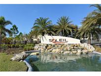 Community entrance sign with water feature, palm trees, and well-maintained landscaping at 8352 Enclave Way # 104, Sarasota, FL 34243