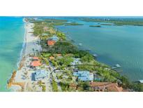 Stunning aerial view of a waterfront home with a private pool and beautiful coastal landscape near the ocean at 1042 N Casey Key Rd, Osprey, FL 34229