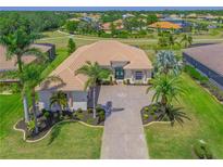 Beautiful single-story home featuring tile roof, lush landscaping and a paver driveway with compass design at 12811 Penguin Dr, Bradenton, FL 34212